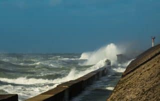 Wave crash into the harbour wall at Calais, France.