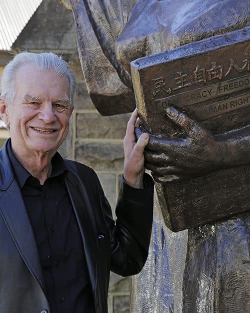 Rev. Bill Crews next to the statue of the Godess of Democracy.