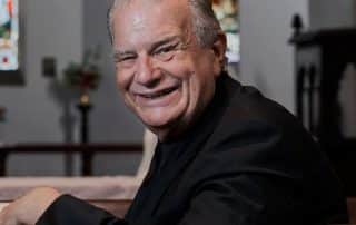 Rev. Bill Crews sitting in Ashfield Uniting church.