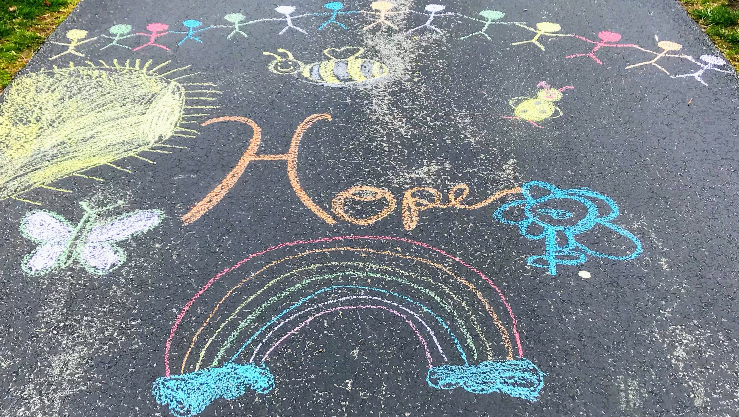 The word "hope" chalkmarker on the pavement.