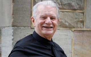 Rev. Bill Crews sitting outside his church.