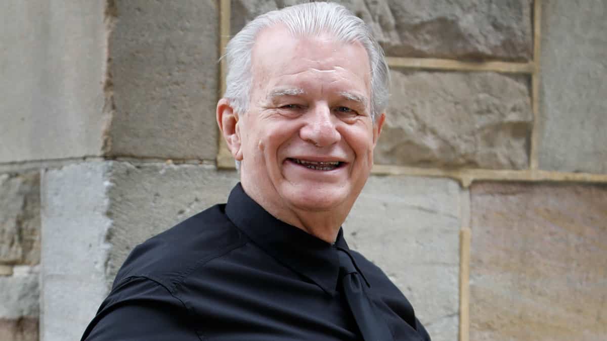 Rev. Bill Crews sitting outside his church.