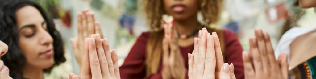 Hands held up in prayer.