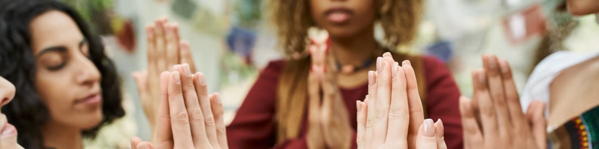 Hands held up in prayer.